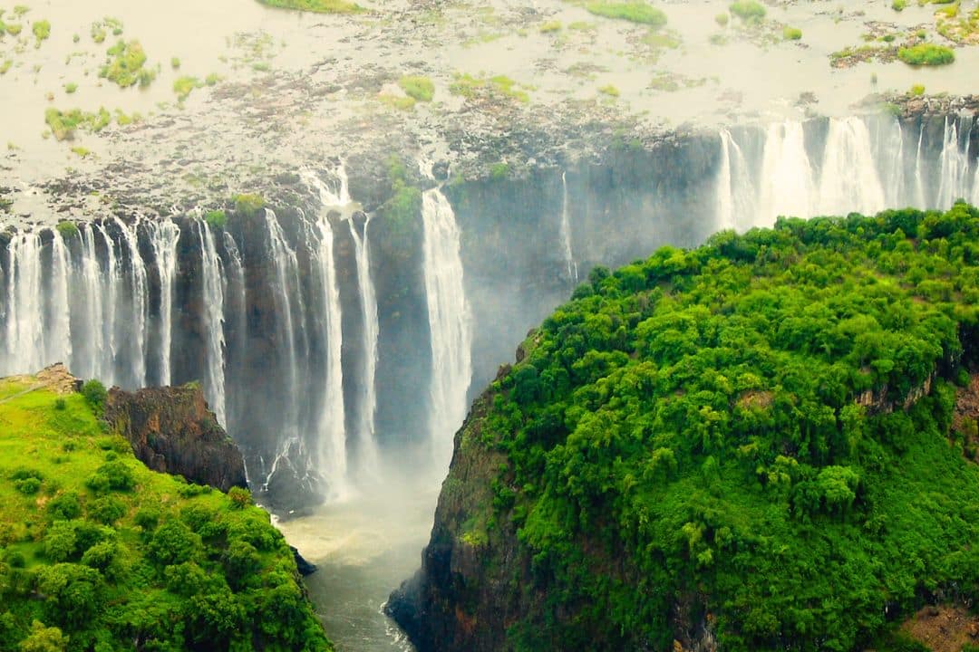 Lush green forests with Victoria Falls in the background